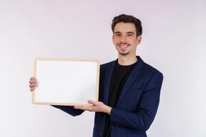 Portrait of happy businessman showing blank signboard on isolated white background photo