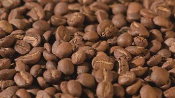 Slow motion of roasted coffee beans falling. Organic coffee seeds. video