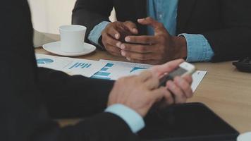 Financial analysts analyze business financial reports on a digital tablet planning investment project during a discussion at a meeting of corporate showing the results of their successful teamwork. video