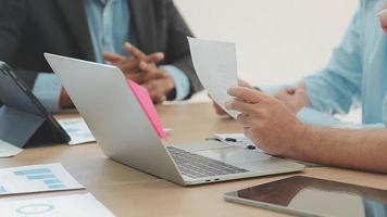 Financial analysts analyze business financial reports on a digital tablet planning investment project during a discussion at a meeting of corporate showing the results of their successful teamwork. video