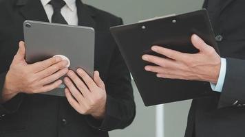 Financial analysts analyze business financial reports on a digital tablet planning investment project during a discussion at a meeting of corporate showing the results of their successful teamwork. video