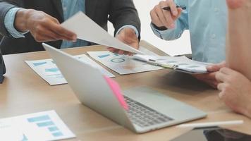 Financial analysts analyze business financial reports on a digital tablet planning investment project during a discussion at a meeting of corporate showing the results of their successful teamwork. video