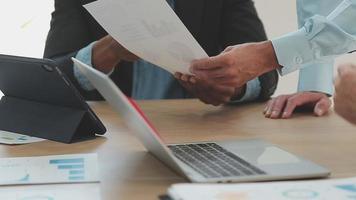 Financial analysts analyze business financial reports on a digital tablet planning investment project during a discussion at a meeting of corporate showing the results of their successful teamwork. video