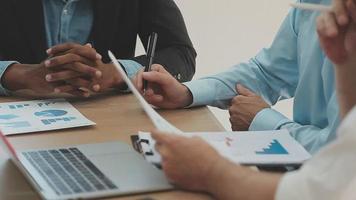 Financial analysts analyze business financial reports on a digital tablet planning investment project during a discussion at a meeting of corporate showing the results of their successful teamwork. video