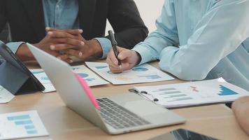 Financial analysts analyze business financial reports on a digital tablet planning investment project during a discussion at a meeting of corporate showing the results of their successful teamwork. video