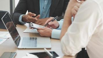 Financial analysts analyze business financial reports on a digital tablet planning investment project during a discussion at a meeting of corporate showing the results of their successful teamwork. video