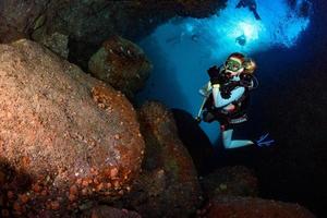 beauty blonde diver girl while swimming underwater photo