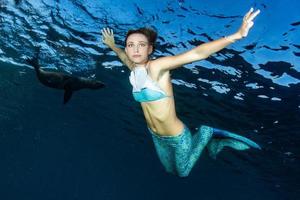 Blonde beautiful Mermaid diver underwater photo