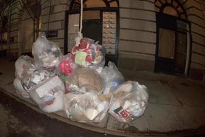 NEW YORK CITY - JUNE 16 2015 Garbage on the street at night photo