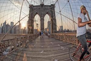 NEW YORK - USA - JUNE, 12 2015 people crossing manhattan bridge photo