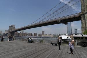 NEW YORK, USA, MAY 2 2019 - Dumbo view of Brooklyn bridge full of tourists photo