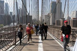 NEW YORK, USA, MAY 2 2019 - Brooklyn bridge full of tourists photo