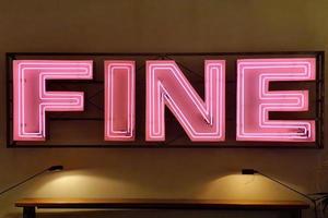 fine pink neon sign on a wall photo