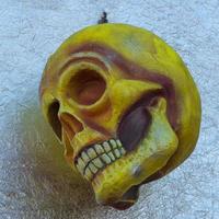 A yellow paper skull on aluminum foil photo