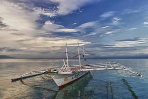 A boat in Turquoise Tropical Paradise Ocean photo