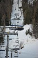 Chair Lift for skiers in winter snow photo
