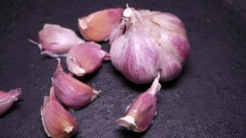 Ripe garlic close-up on a black background video