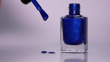 Blue nail polish on white background video