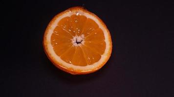 liquide mon chéri les flux vers le bas lentement de un Orange bague sur une noir Contexte video