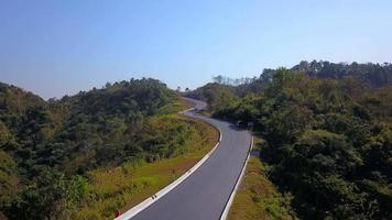 The aerial view of infamous number 3 shape highway into the mountain of Nan Province, Thailand for tourism and traveling concept video