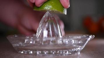 Squeeze lime juice close up with a glass squeezer video