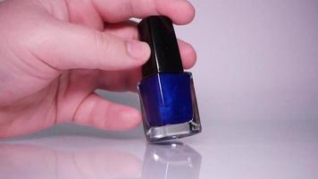 Blue nail polish on white background video