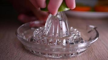 Squeeze lime juice close up with a glass squeezer video