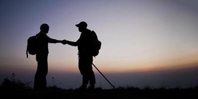 Silhouette of Teamwork helping hand trust help photo