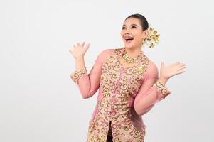 Young beautiful woman dress up in local culture in southern region with excited posture photo