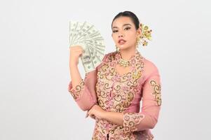 Young beautiful woman dress up in local culture in southern region pose with banknote photo