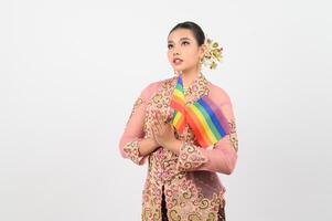 Young beautiful woman dress up in local culture in southern region with rainbow flag photo