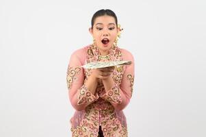 Young beautiful woman dress up in local culture in southern region pose with banknote photo