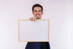 Portrait of happy businessman showing blank signboard on isolated white background photo