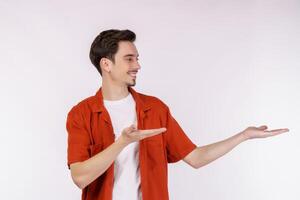 Portrait of happy smiling young man presenting and showing your text or product isolated on white background photo