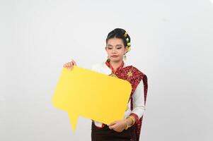 Young beautiful woman in Thai lanna costume with blank speech bubble sign photo