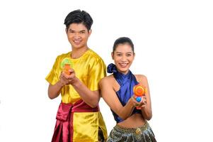 Young couple enjoy with water gun on Songkran festival photo