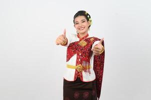 Young beautiful woman in Thai lanna costume with thumb up posture photo