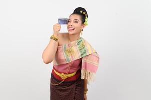 Portrait of Beautiful Thai Woman in Traditional Clothing Posing with credit card photo