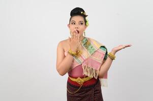 Young beautiful woman in northeastern dress stand and open palm posture photo