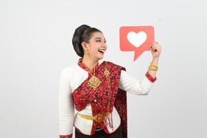 Young beautiful woman in Thai lanna costume with card card in heart symbol photo