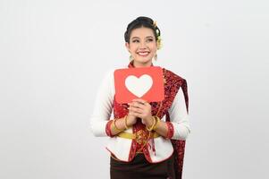 Young beautiful woman in Thai lanna costume with card card in heart symbol photo