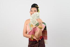 Portrait of Beautiful Thai Woman in Traditional Clothing Posing with fan Banknote photo