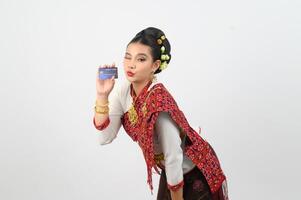 Young beautiful woman in northeastern dress show credit card posture photo