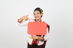 Young beautiful woman in Thai lanna costume with blank speech bubble sign photo