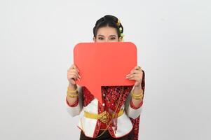 Young beautiful woman in Thai lanna costume with blank speech bubble sign photo