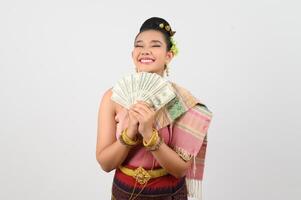 Portrait of Beautiful Thai Woman in Traditional Clothing Posing with fan Banknote photo