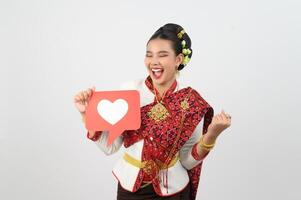 Young beautiful woman in Thai lanna costume with card card in heart symbol photo