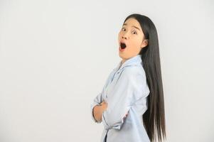 Portrait of Excited young asian woman in blue shirt crossed arm isolated on white background photo