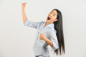 Portrait of young asian woman showing winner gesture over isolated white background photo