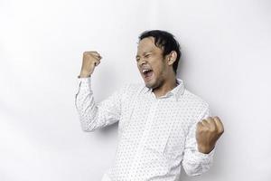 A young Asian man with a happy successful expression wearing white shirt isolated by white background photo